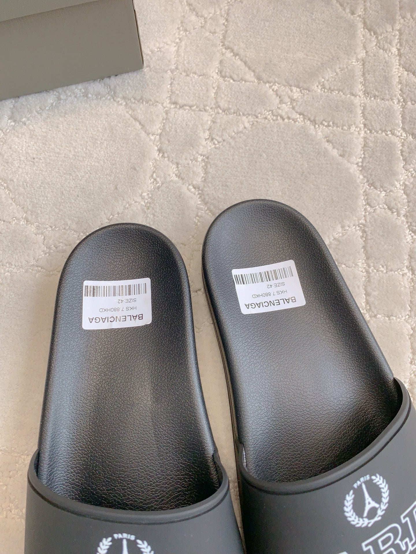 Black Balenciaga slide sandals with logo on heel strap and white size labels