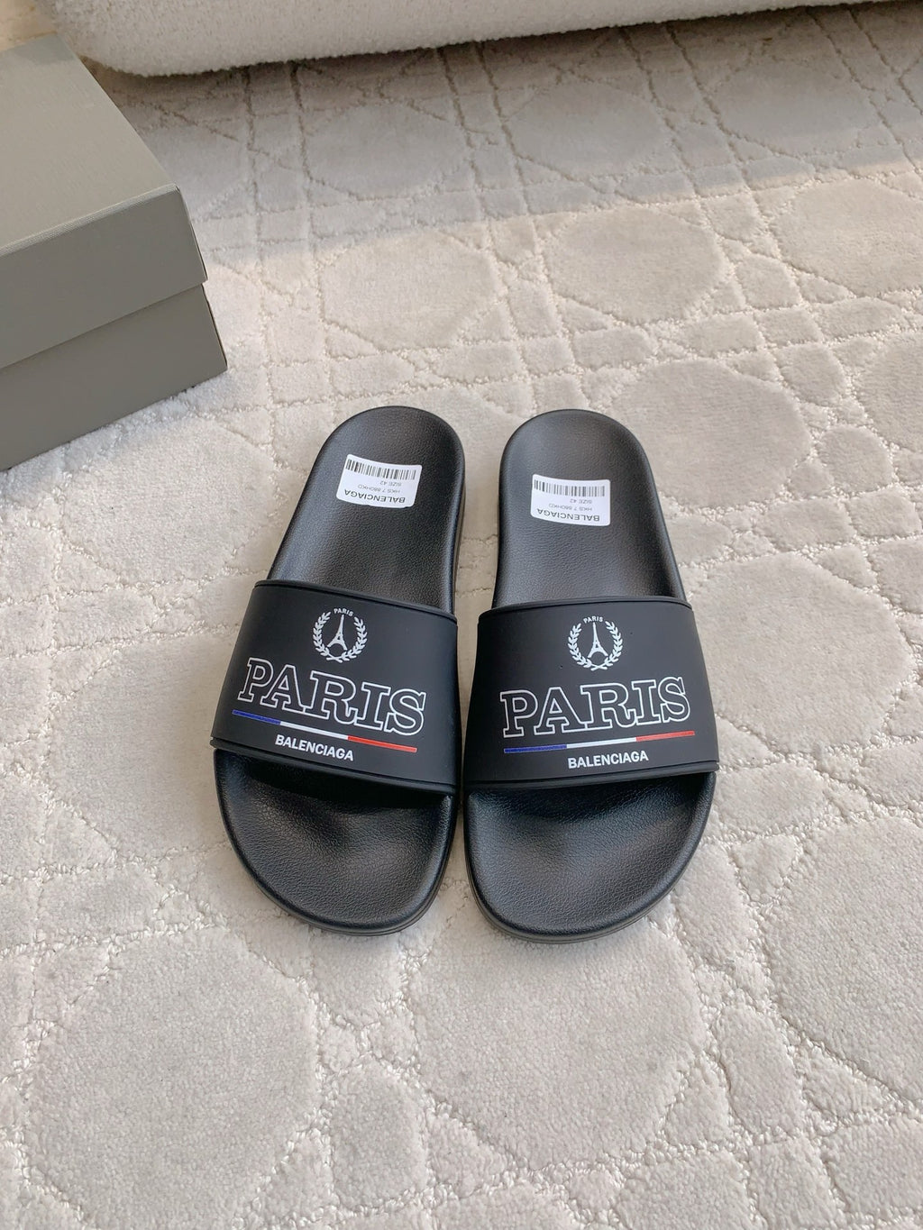 Black Balenciaga slide sandals with Paris logo on wide front strap