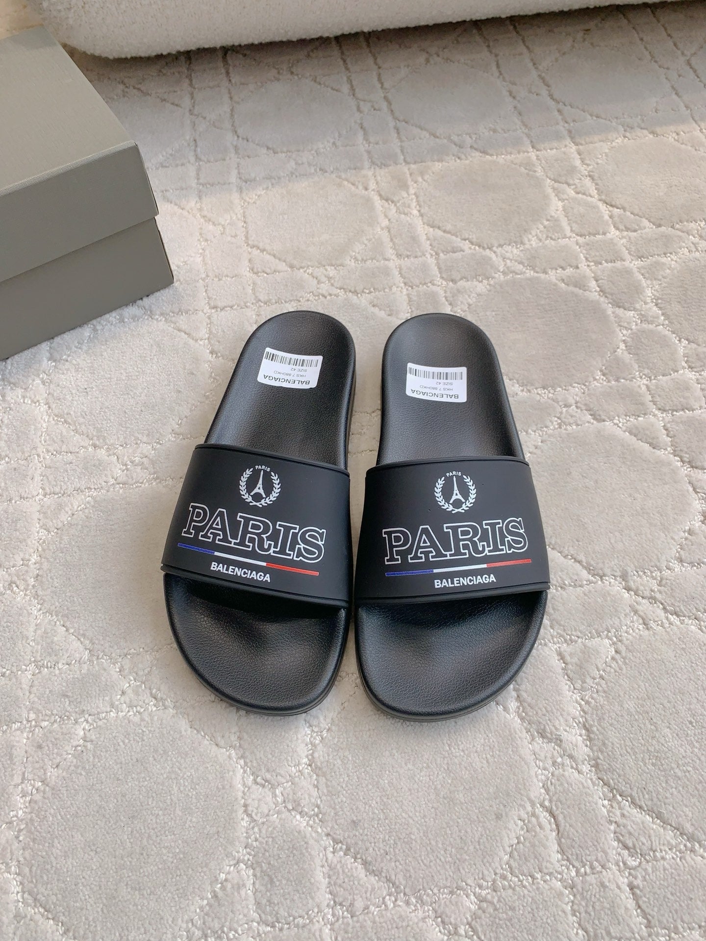 Black Balenciaga slide sandals with Paris logo on wide front strap