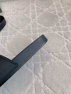 Black Balenciaga slide sandal strap and footbed, close side view
