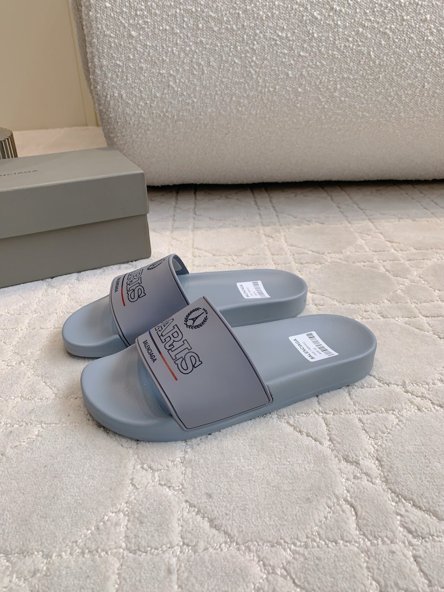 Balenciaga light blue slide sandals, one pair showing side and strap graphics