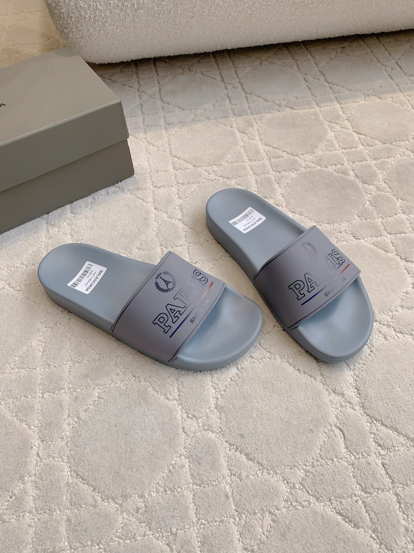 Balenciaga light blue slide sandals, two angles with PARIS logo on straps