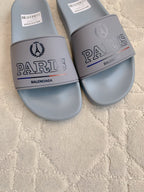 Balenciaga light blue slide sandals, close-up of PARIS and BALENCIAGA logos