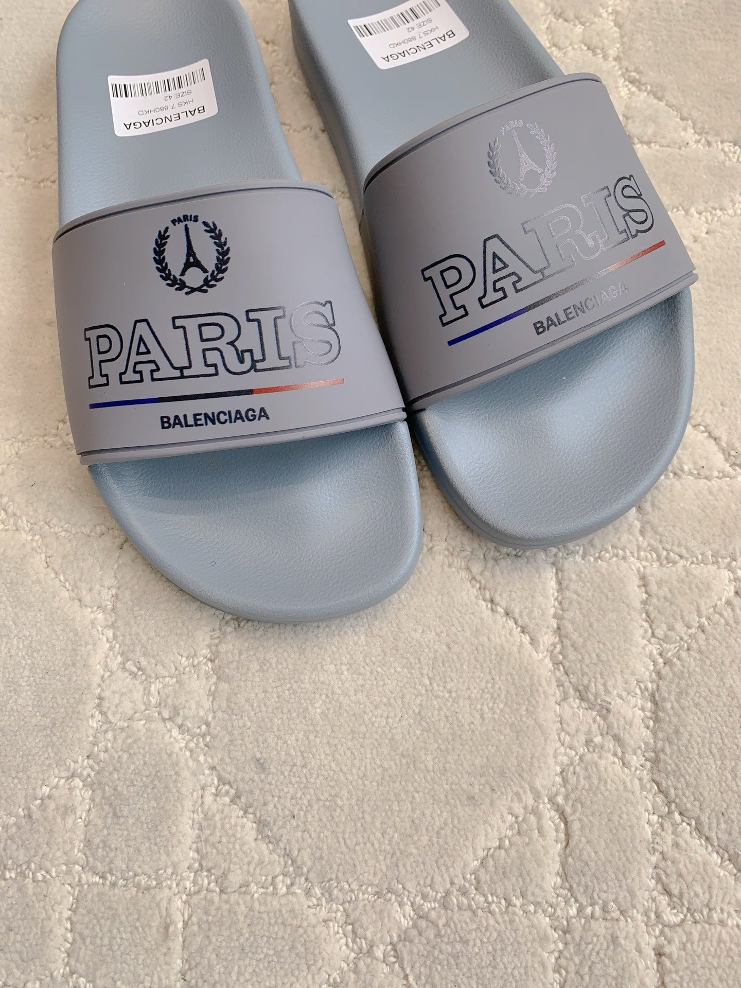 Balenciaga light blue slide sandals, close-up of PARIS and BALENCIAGA logos