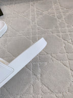White slide sandal footbed and strap, partial side view.