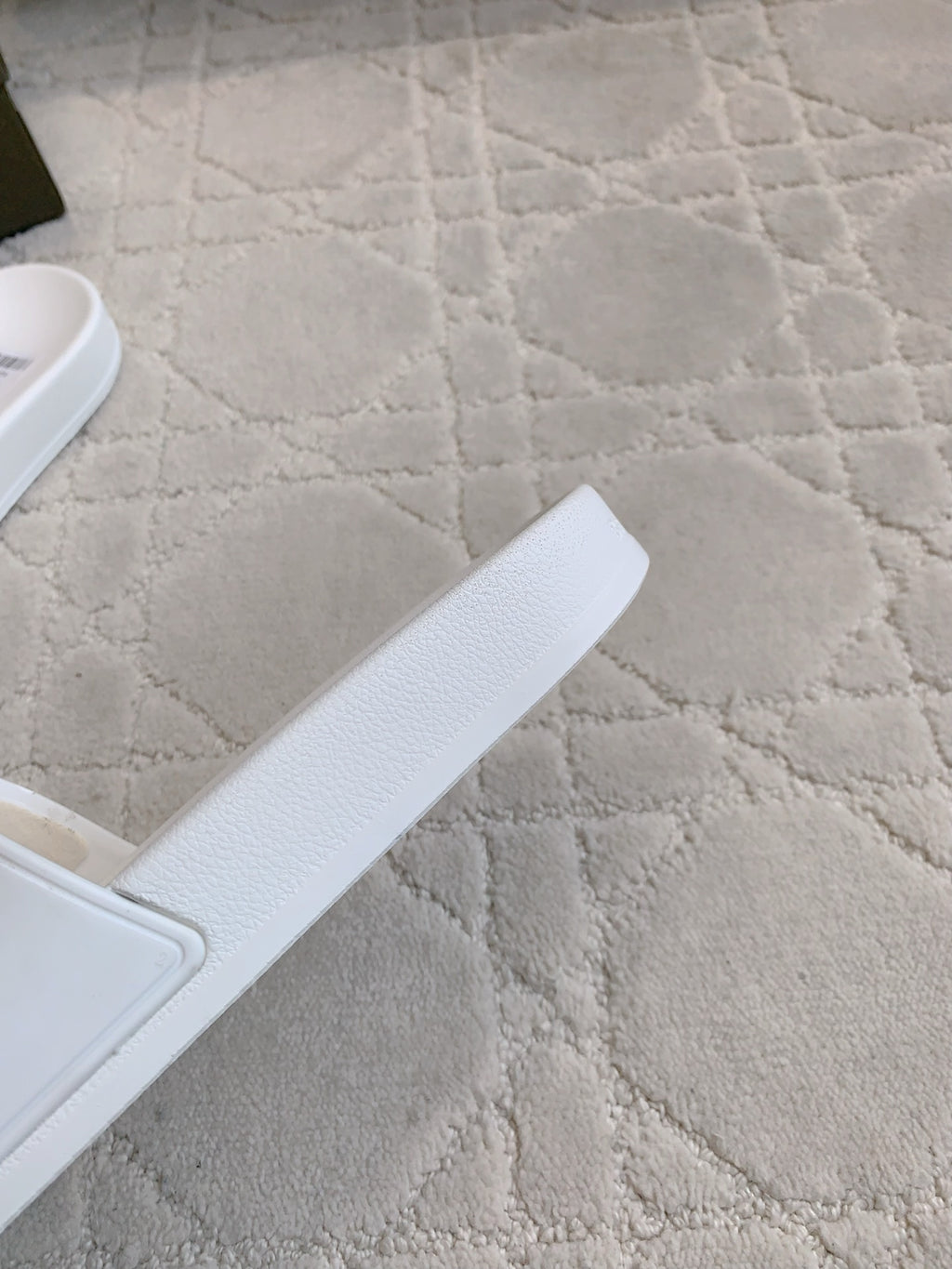 Balenciaga white slide sandals, close-up of textured sole edge