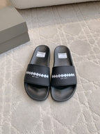 Black slide sandals with wide strap and white logo print, EST. 1917 detail