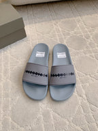 Light blue slide sandals with logo strap and padded footbeds