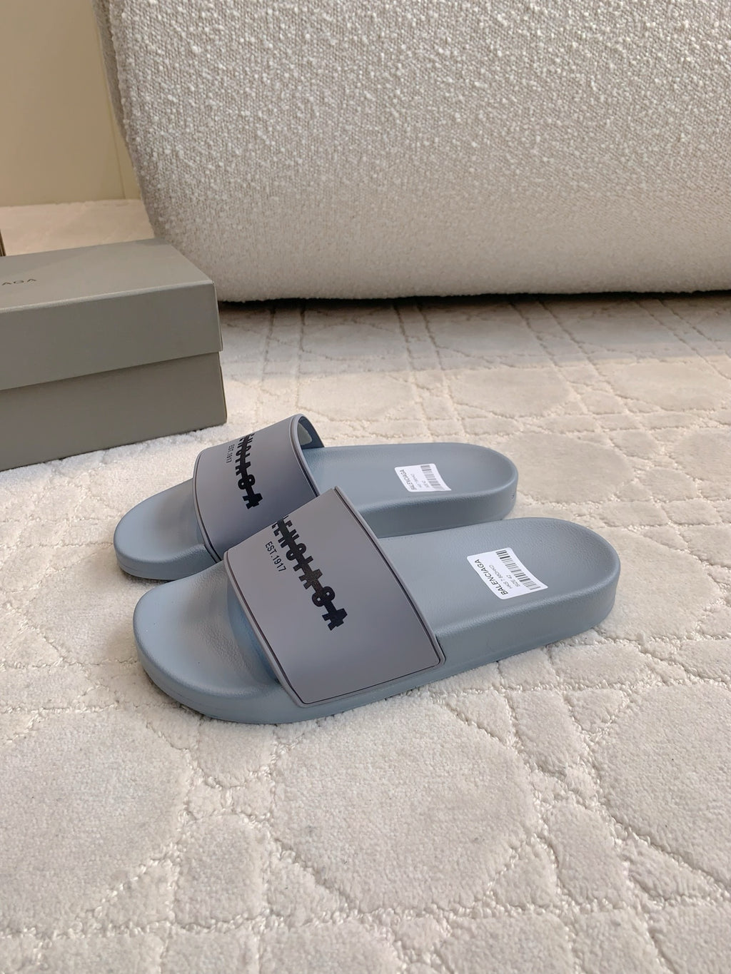 Light blue slide sandals with thick strap and logo detail
