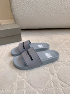 Light blue slide sandals with thick strap and logo detail