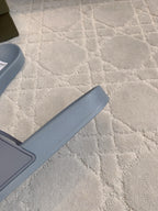 Light blue slide sandal profile with wide strap and footbed