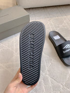 Balenciaga black slide sandal outsole with ridged tread and logo embossing