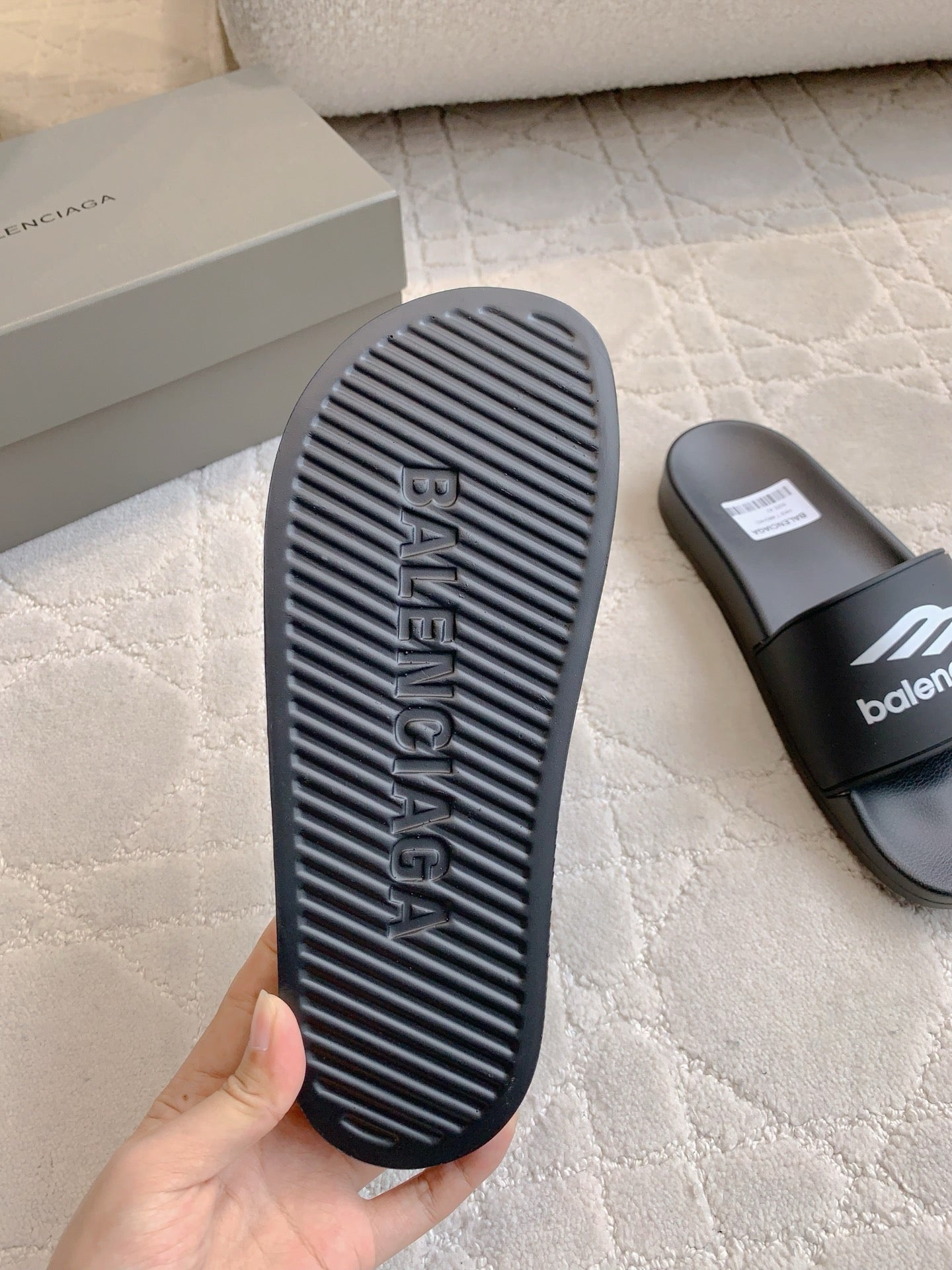 Balenciaga black slide sandal outsole with ridged tread and logo embossing