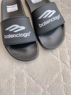 Balenciaga black slide sandals close-up, wide strap with white logo