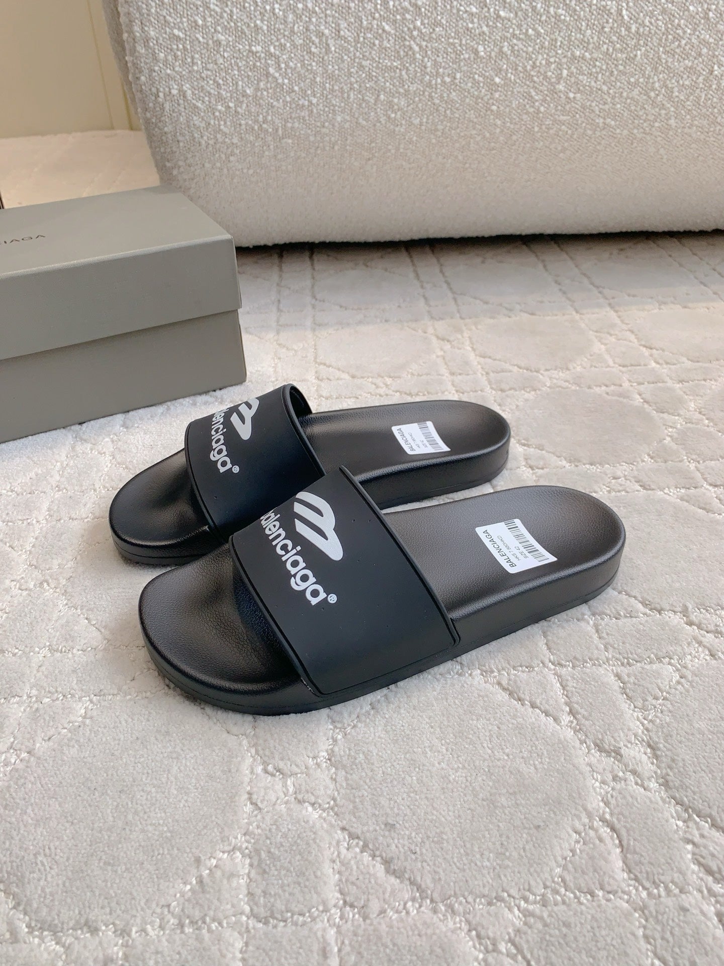 Balenciaga black slide sandals with cross strap and printed logo on footbed