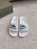 White Balenciaga slide sandals with “balenciaga” logo on the straps