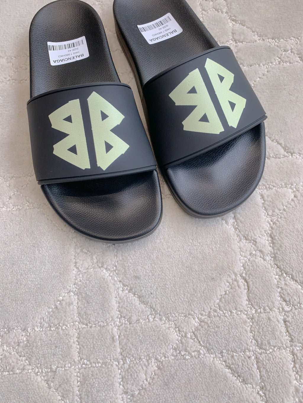 Balenciaga black slide sandals with green logo on front straps