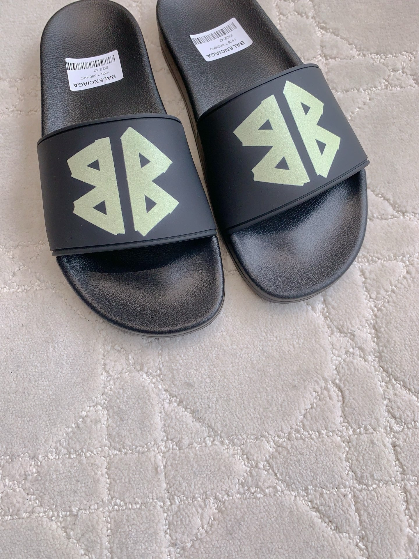 Balenciaga black slide sandals with green logo on front straps