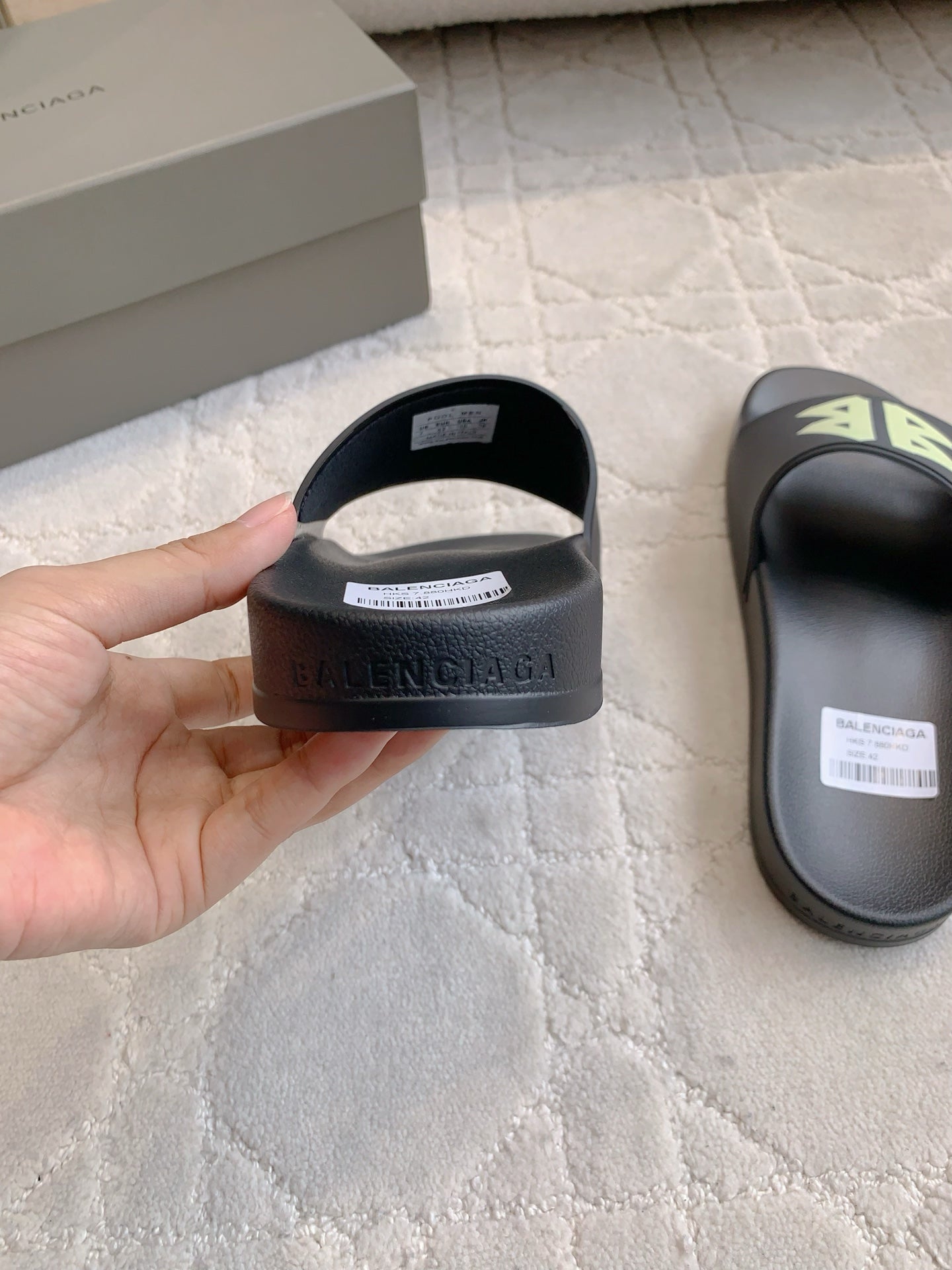 Balenciaga black slide sandal heel, hand holding inside edge