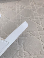 White Balenciaga slide sandal strap and footbed, close-up.