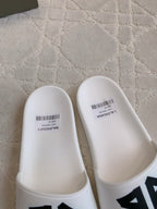White Balenciaga slide sandals, top view with printed size label.