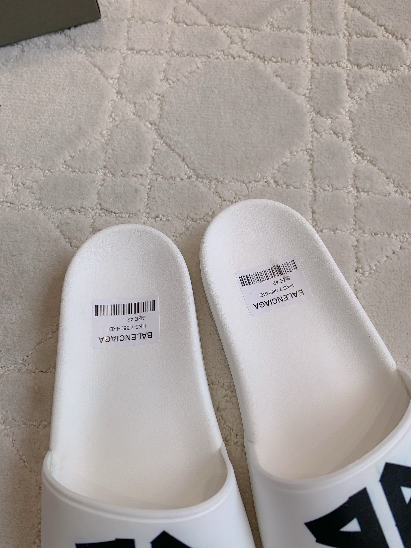 White Balenciaga slide sandals, top view with printed size label.