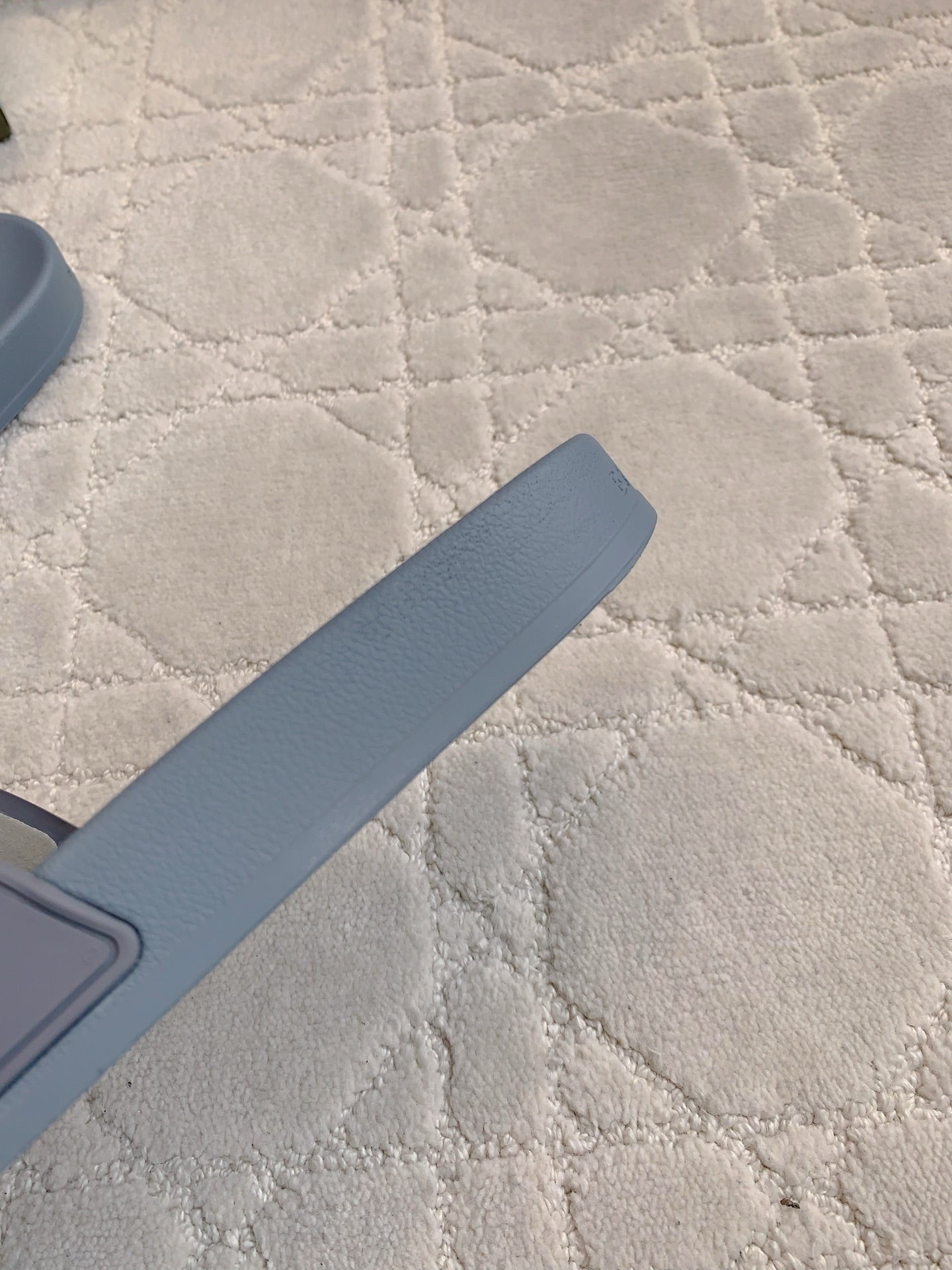 Balenciaga slide sandal strap, light blue rubber sole edge visible