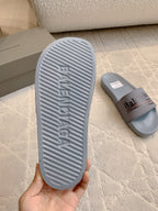 Balenciaga slide sandal outsole, light blue-gray textured tread and logo