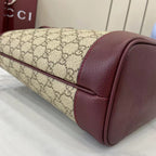 Gucci tote bag corner with GG canvas and burgundy leather side panel and curved seam