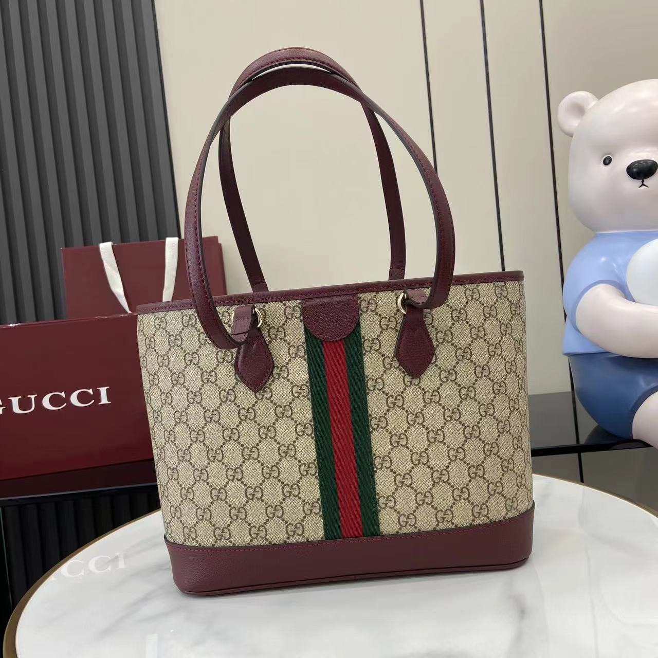 Gucci tote bag with GG canvas, burgundy top handles, and center green-red web stripe