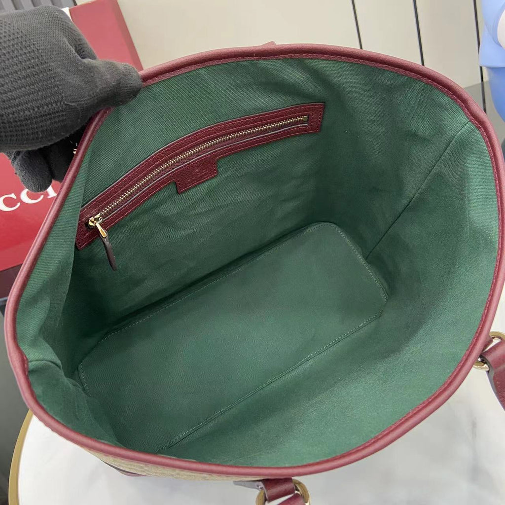 Gucci tote bag interior with green fabric lining and burgundy top zipper