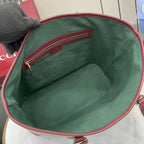 Gucci tote bag interior with green fabric lining and burgundy top zipper