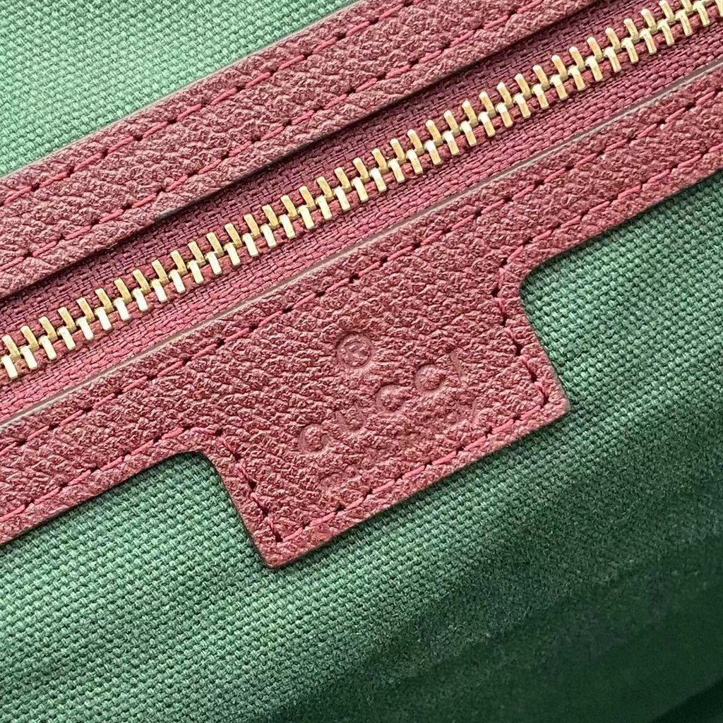 Gucci tote bag zipper detail with pink textured leather and green label patch