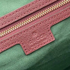 Gucci tote bag zipper detail with pink textured leather and green label patch