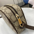 Gucci crossbody bag zipper hardware on beige GG canvas with brown trim