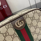 Gucci crossbody bag front logo patch with gold-toned emblem on brown leather
