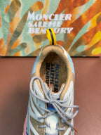Close-up of light blue and white sneaker tongue with lace-up eyelets
