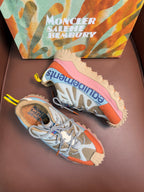 Blue and orange low-top sneakers with pink soles and lace-up front