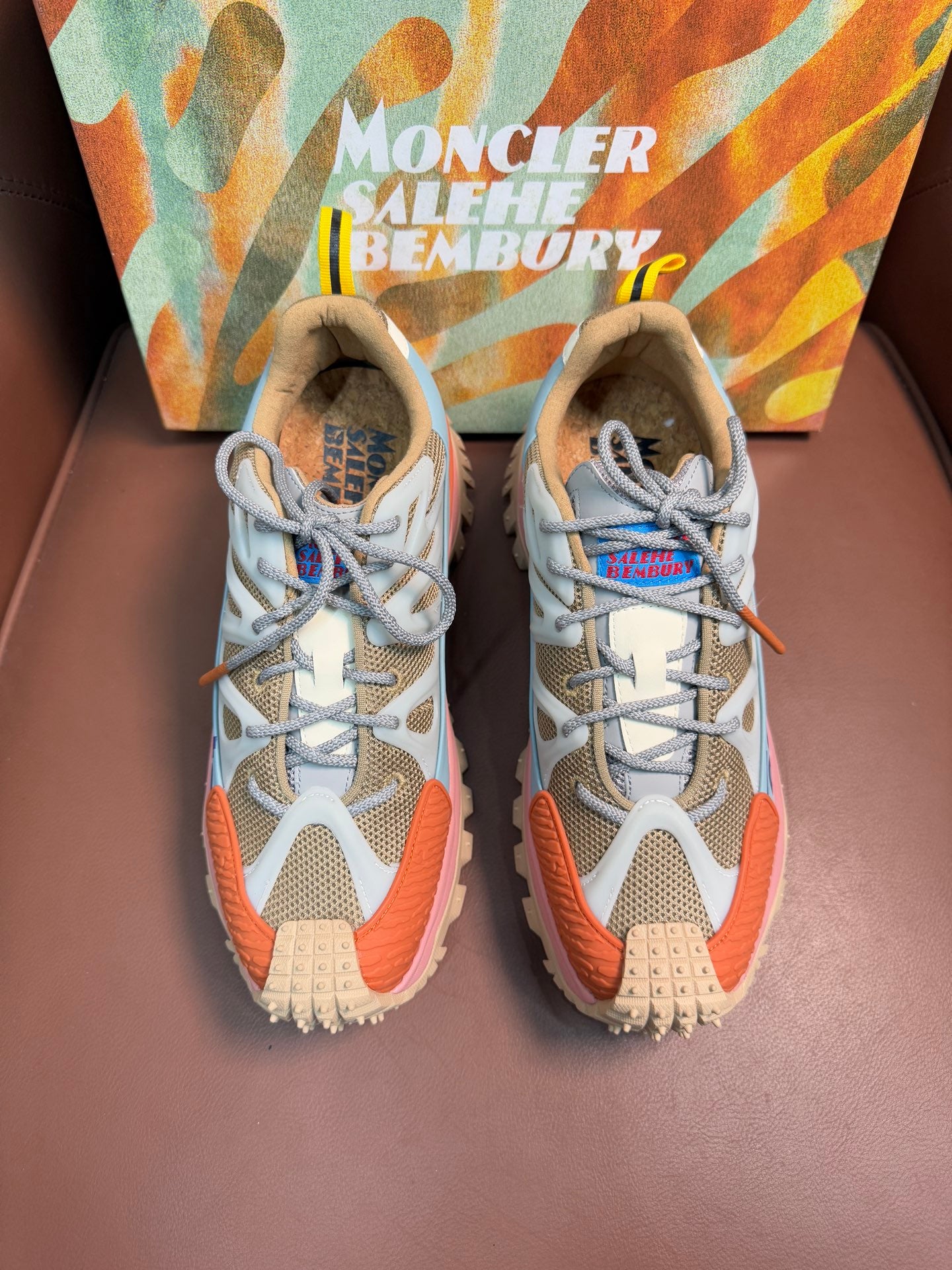 Colorful low-top sneakers with gray, light blue, orange, and pink accents