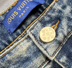 Denim jeans interior tag and round gold-tone snap button