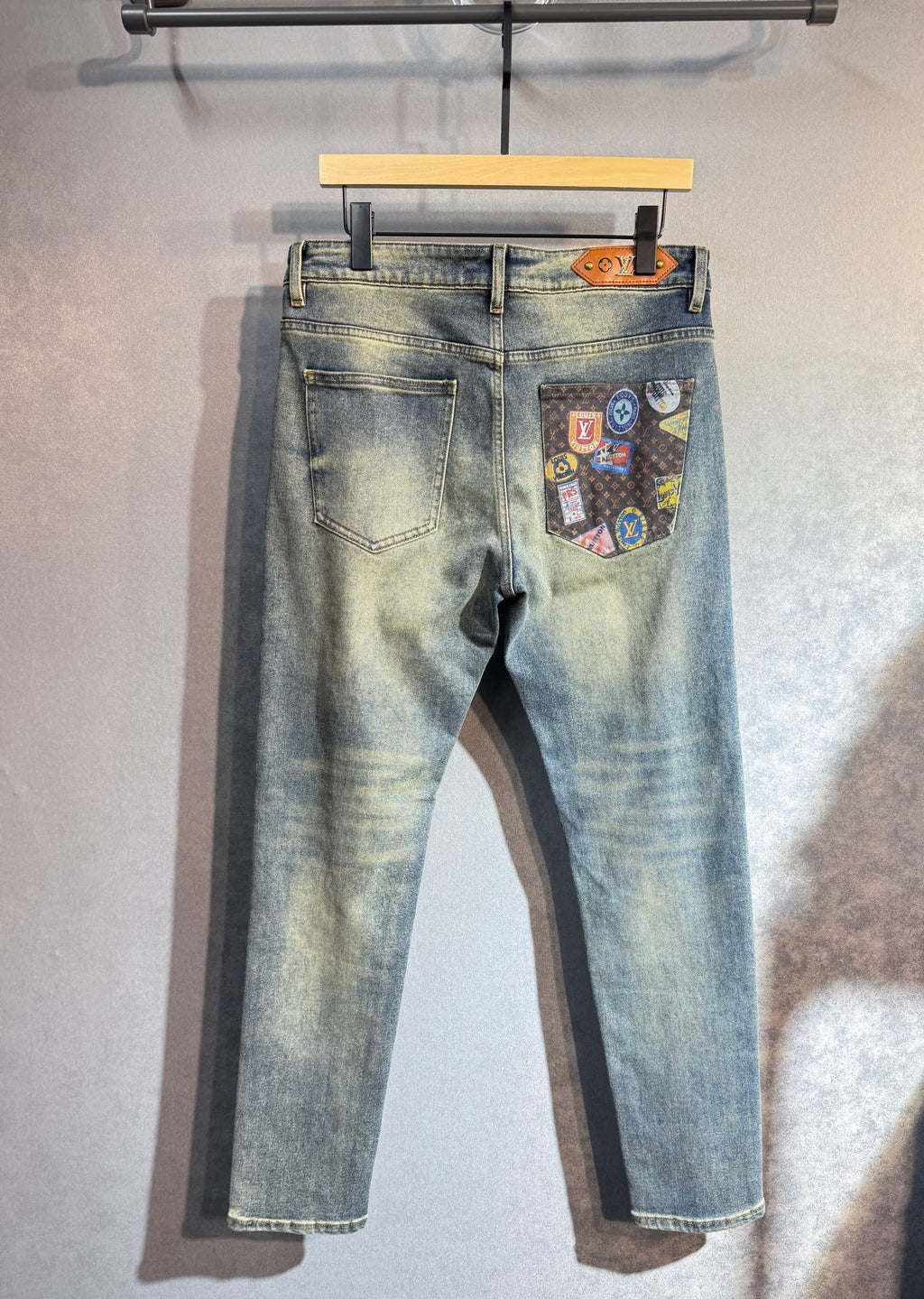 Light wash denim pants with patch pocket and gold button details