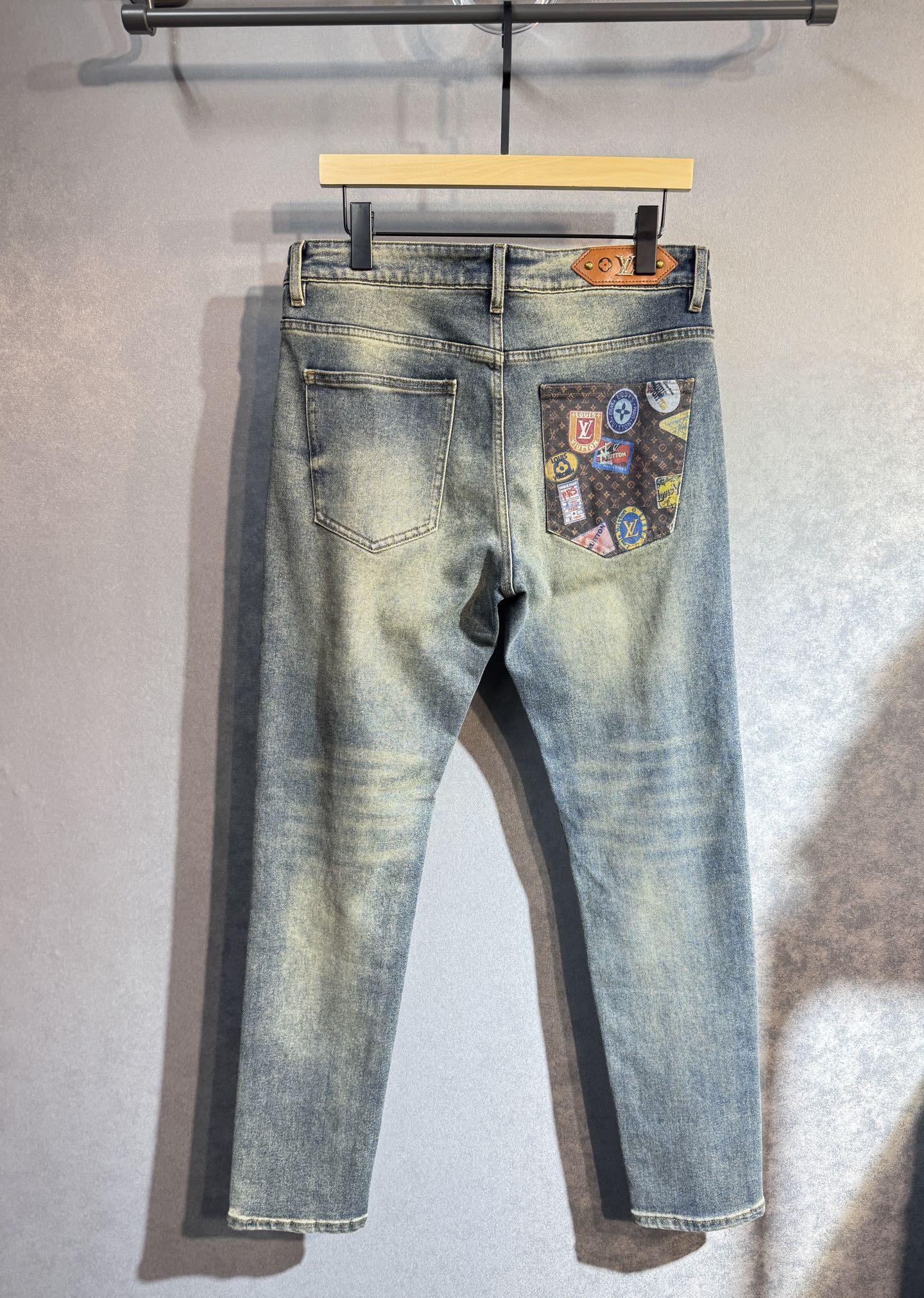 Light wash denim pants with patch pocket and gold button details