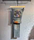 Denim pants with multicolor patch graphic on front leg