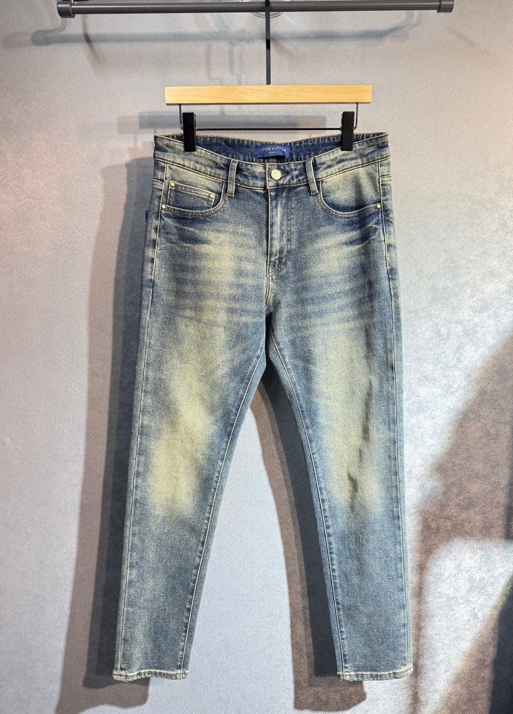 Light wash denim pants with belt loops and button closure