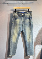 Light wash denim pants with belt loops and button closure