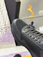 Black Louis Vuitton sneaker close-up, mesh upper and lace panel with textured toe.