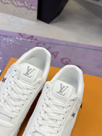 Louis Vuitton white sneakers, two shoes side by side with LV emblem