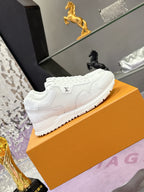 Louis Vuitton white sneakers with embossed pattern, side view