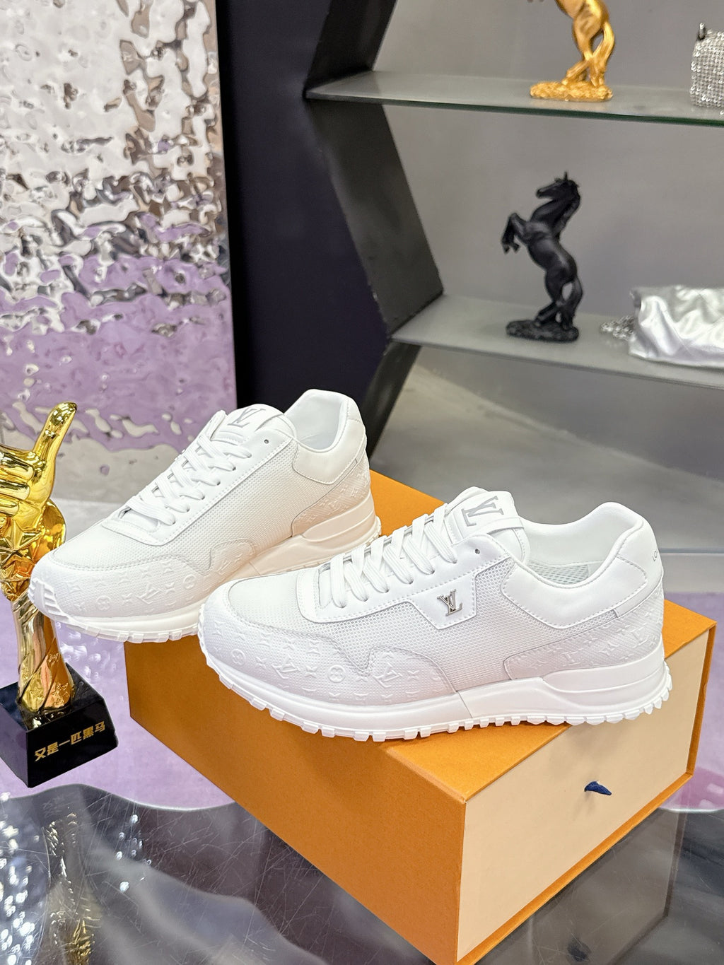 Louis Vuitton white sneakers pair on shoebox, lace-up and logo detail