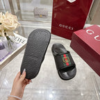 Black slide sandal underside sole pattern, with one shoe on side